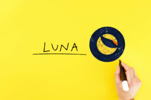 man draws a terra icon next to the inscription luna. blockchain and cryptocurrency concept